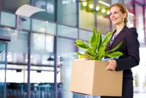 Woman packing and moving an office in a box