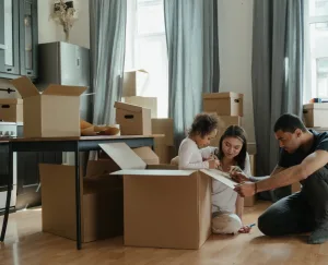 Family of three beginning to pack a kitchen
