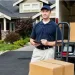 Professional mover in front of an open moving truck